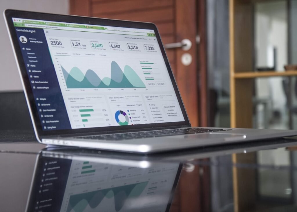 Laptop displaying digital marketing analytics and cost data