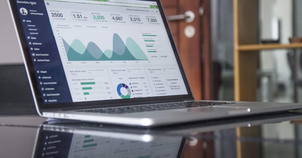 Laptop showing analytics dashboard comparing AI search optimization versus traditional SEO